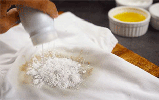 Using baby powder to remove cooking oil stains